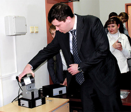 Deputy Director of Engineering of the NT-MDT Vyacheslav Polyakov shows a scanning probe microscope NANOEDUCATOR II