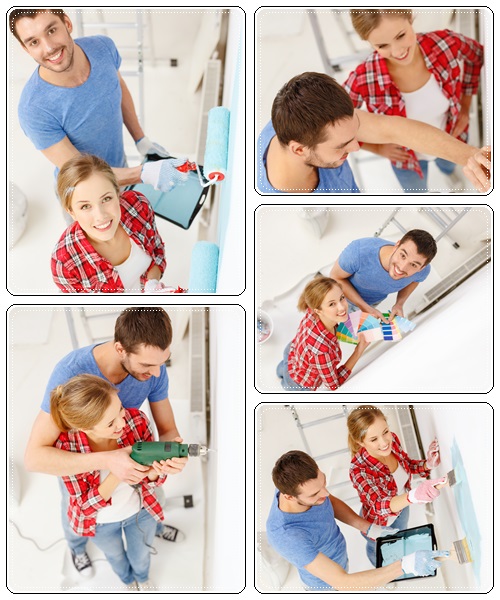 Smiling couple painting wall at home - stock photo
